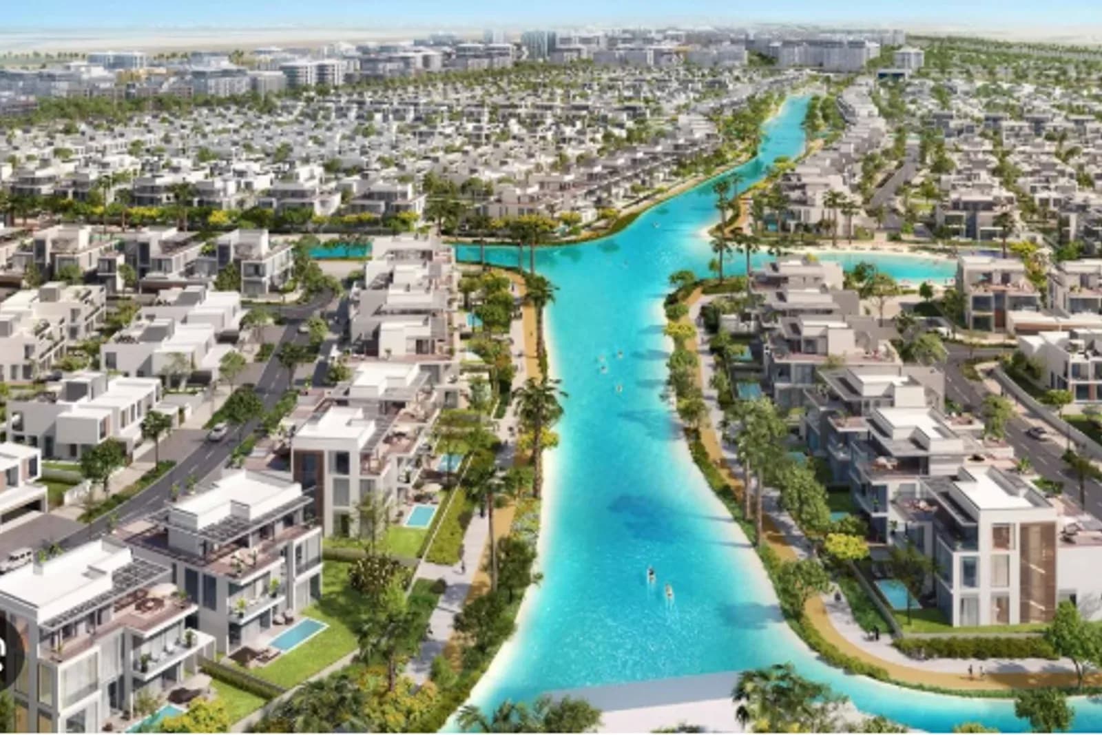Turquoise lagoon lined with villas and paddleboarders in Dubai South